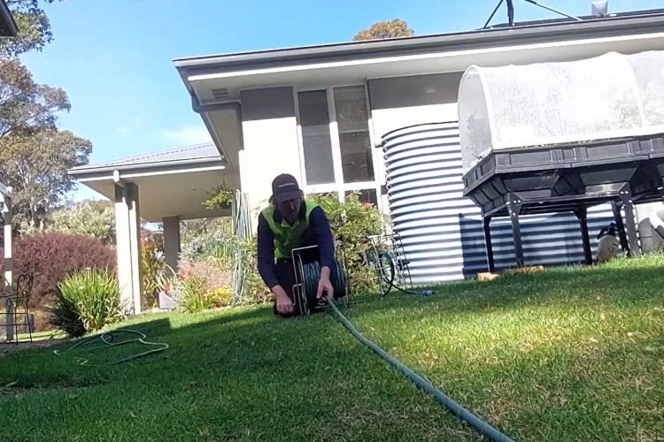 
Concluding a busy workday, the narooma downpipe cleaner is organizing his hose.