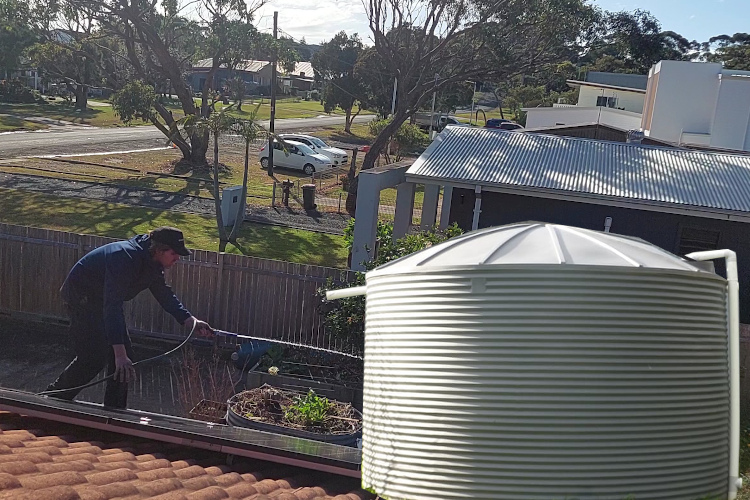 
narooma Gutter Cleaner Flushes Gutters on Rainwater-Reliant Site